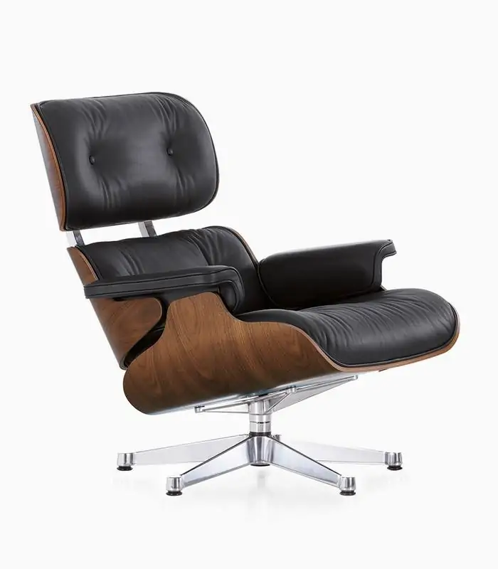 Black Eames-style lounge chair with molded wood shell and leather cushions