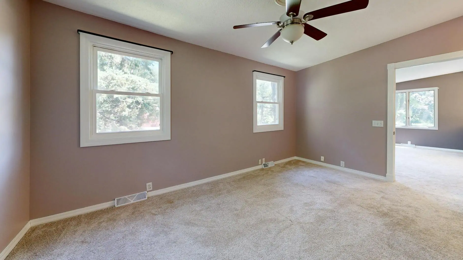 Soft greige painted living room with warm light and oak floors