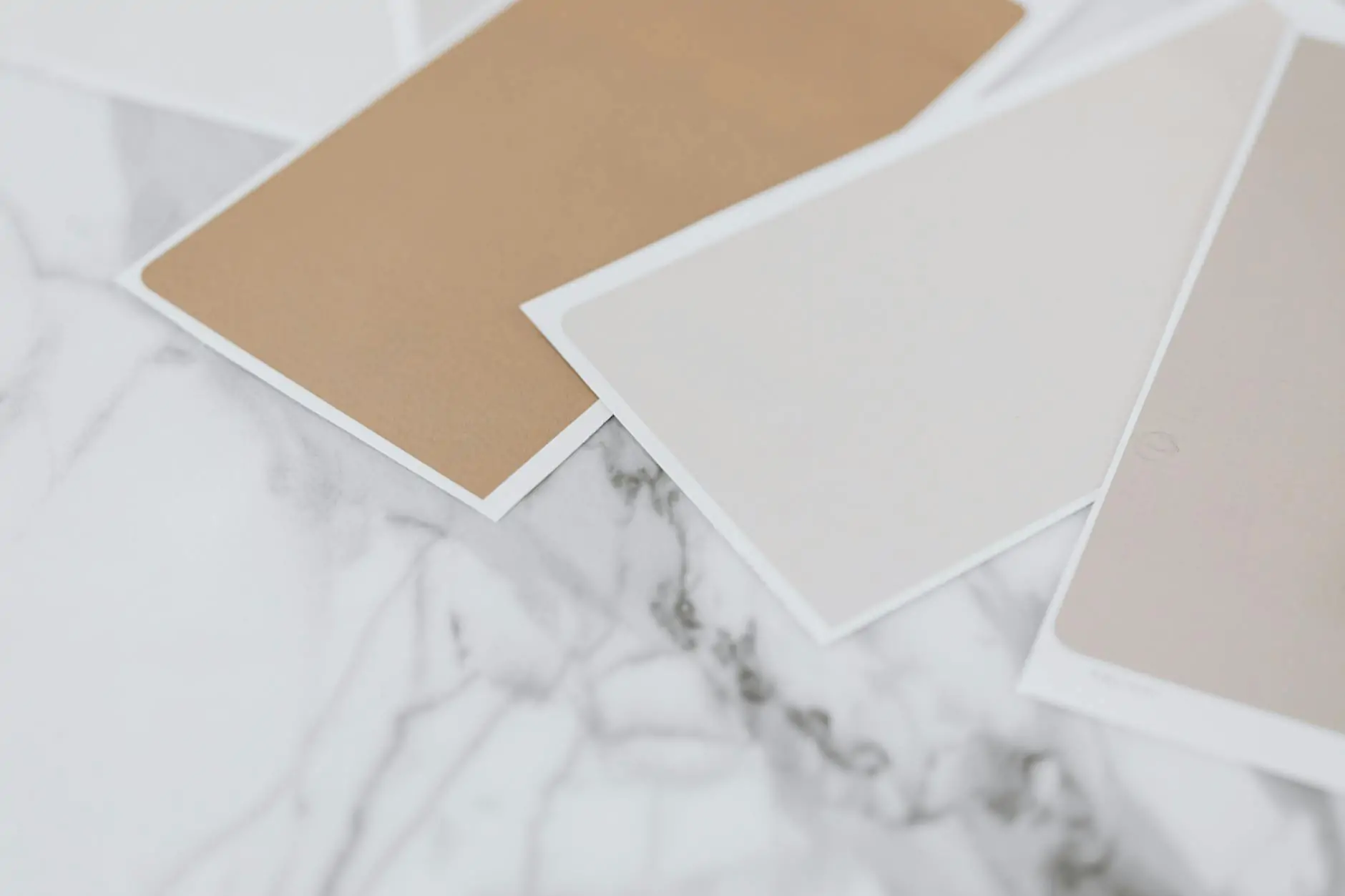 Stack of neutral beige and greige paint swatches