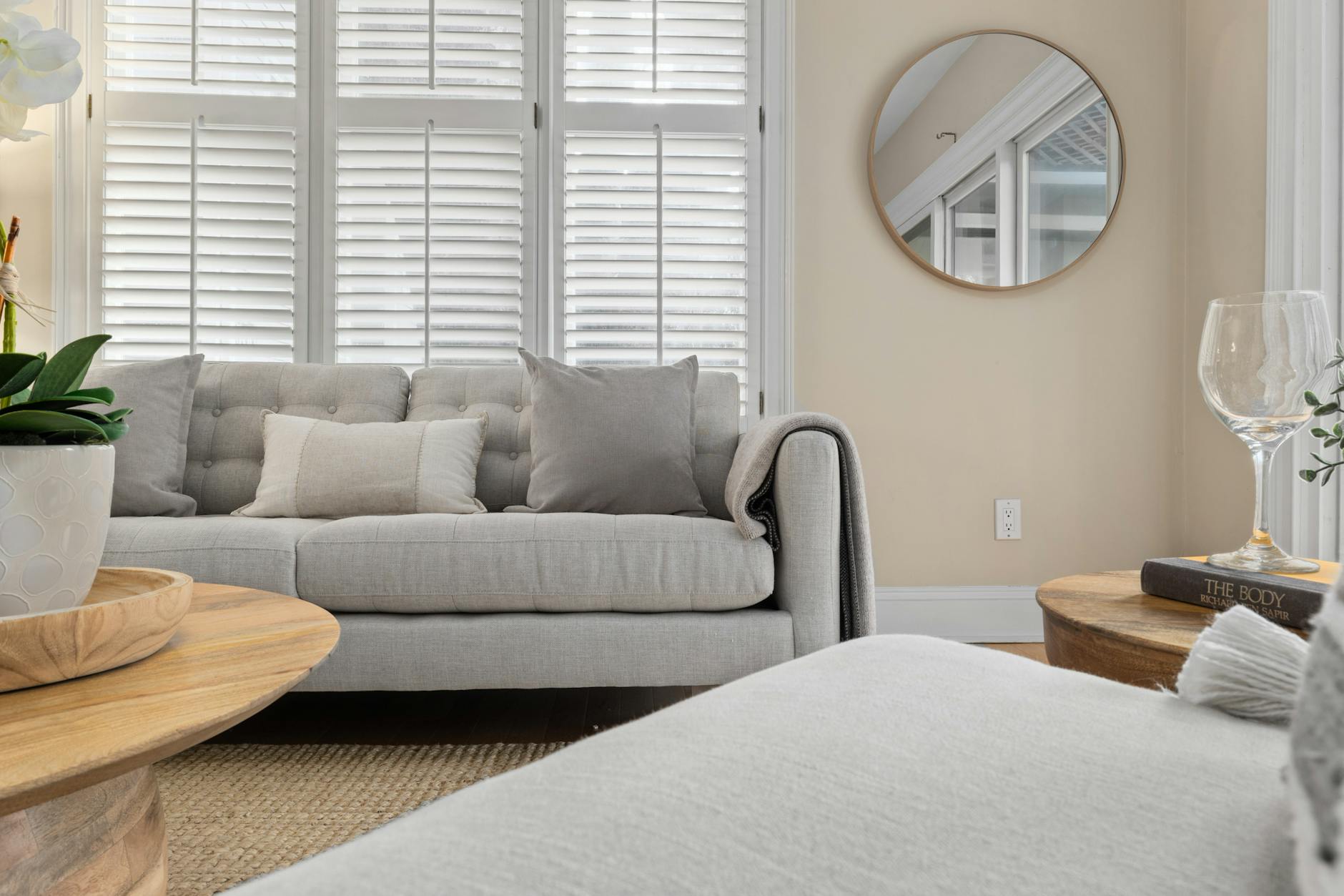 Coastal luxe living room with linen sofa, driftwood and warm white walls