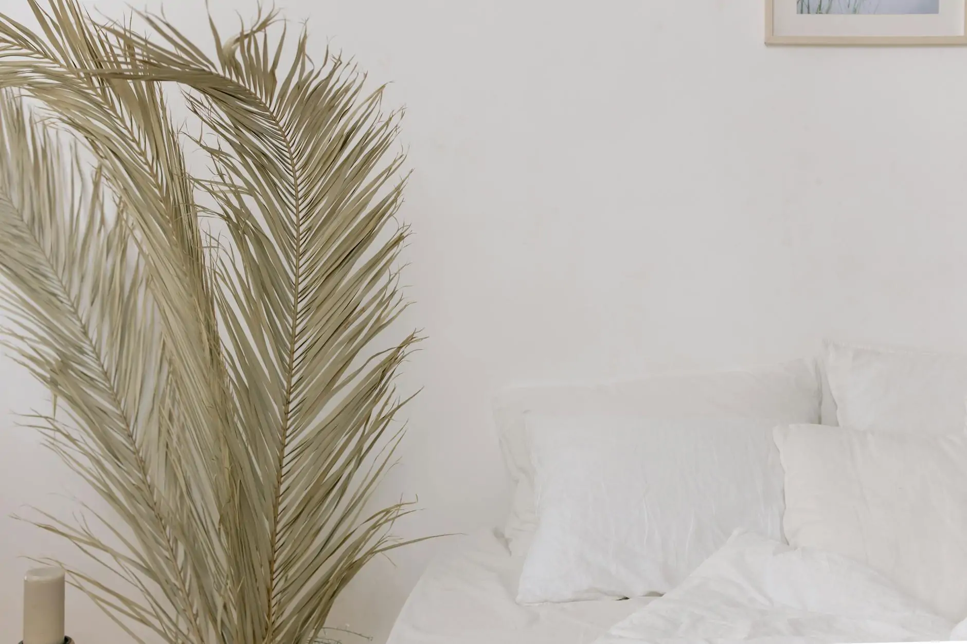 Linen-dressed bed in a soft coastal luxe bedroom
