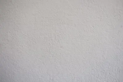 Limewash plaster wall in soft cream with warm light
