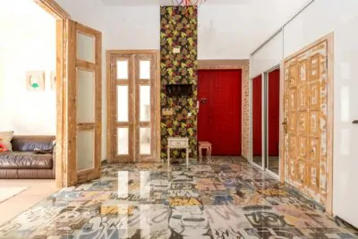 Maximalist living room with rich colors, gallery wall and layered patterns