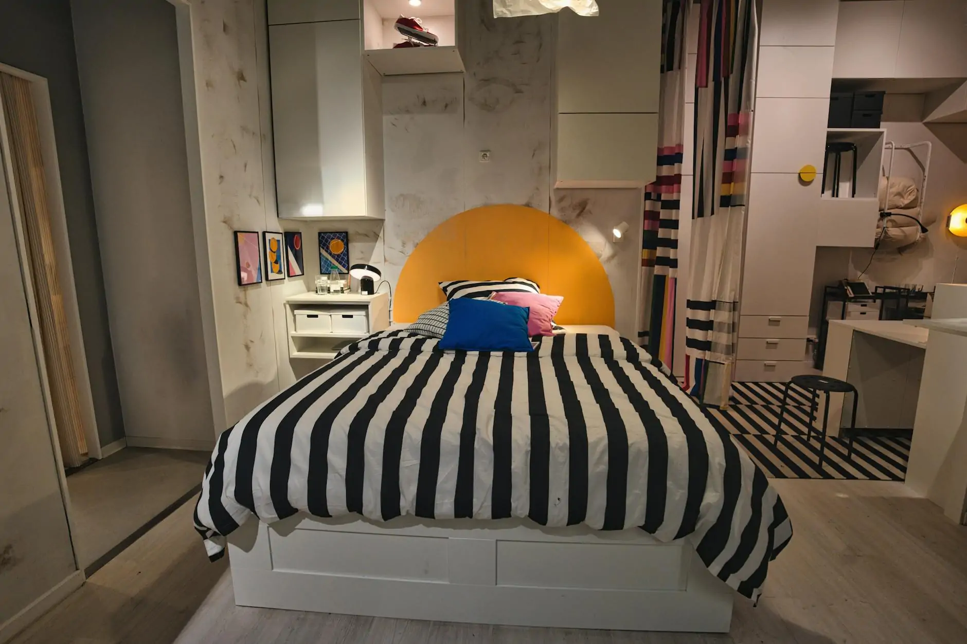 Maximalist bedroom with patterned wallpaper and layered textiles