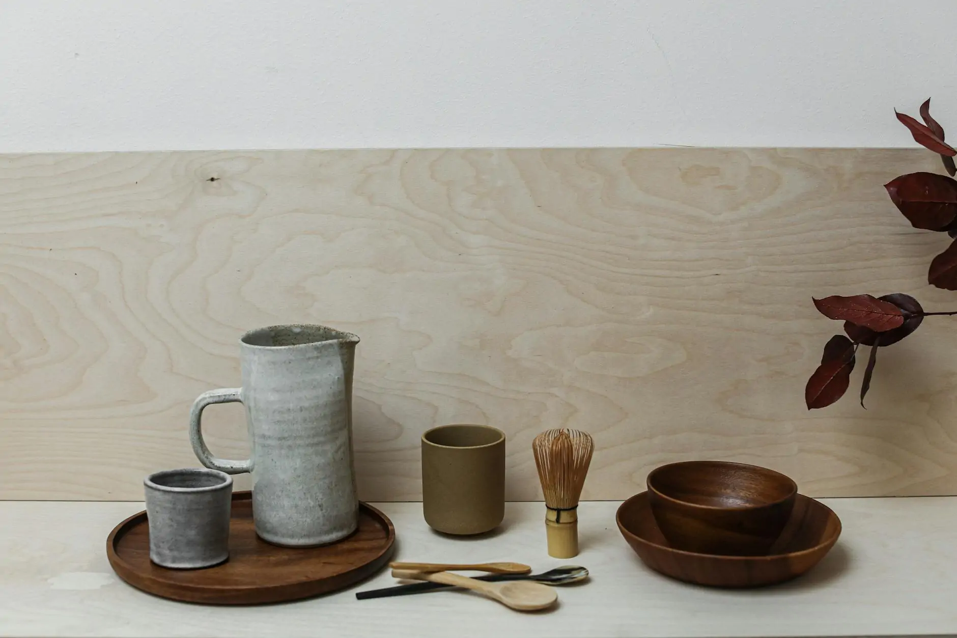 Handmade ceramic vessels on weathered wood — wabi sabi styling