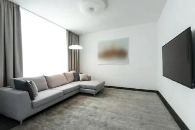 All-white living room with layered cream textures and warm wood floors