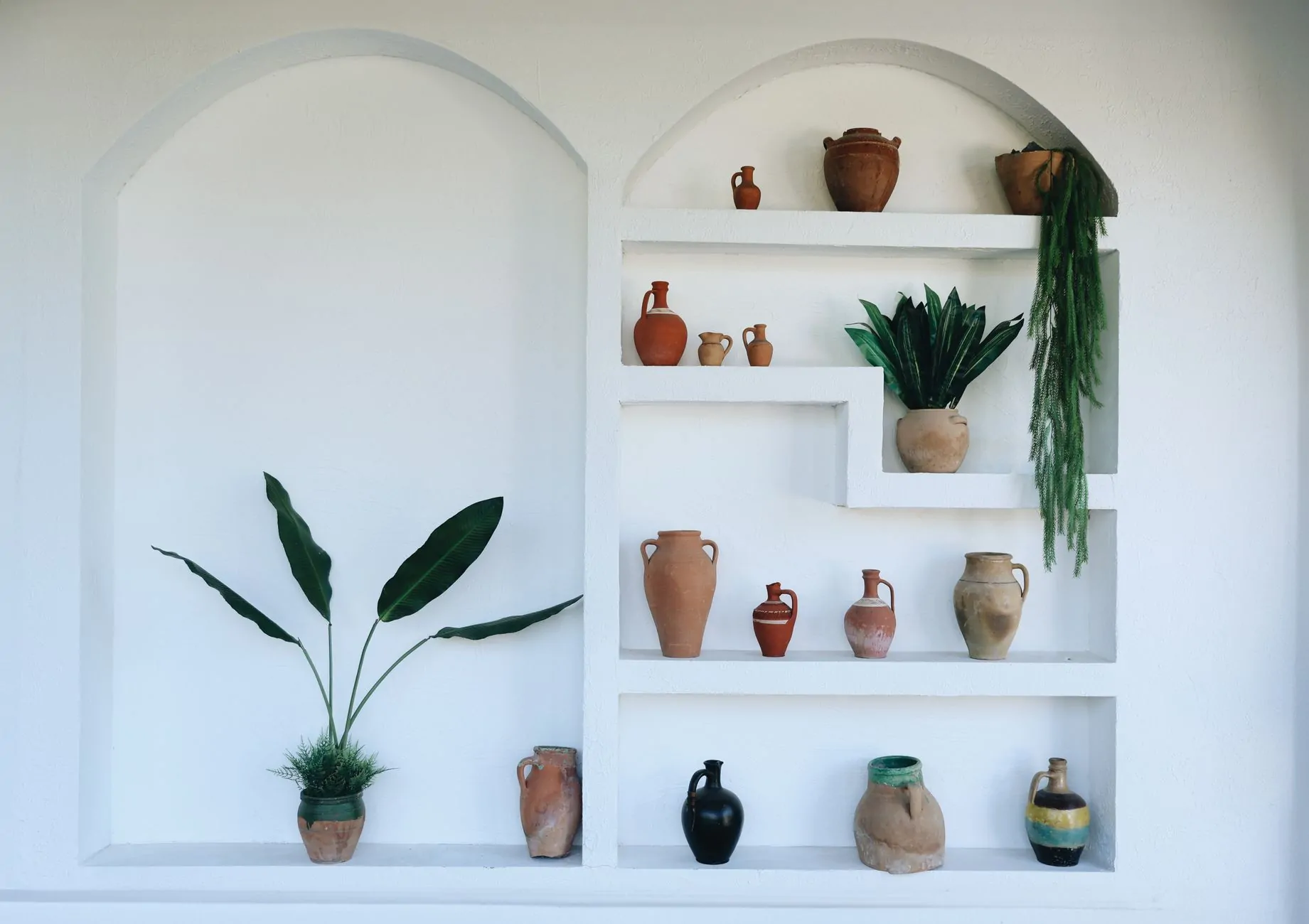 Terracotta pots styled with plants in a warm home decor setting