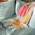 Colorful standard throw blanket draped across a sofa arm