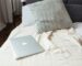 Lightweight cooling blanket folded across a neutral summer bed
