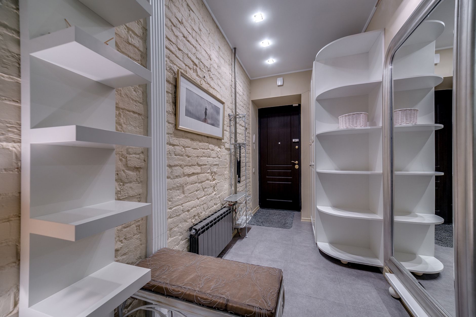 Modern entryway with built-in shelving and a storage bench