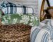 Folded oversized throws stored in a woven living room basket