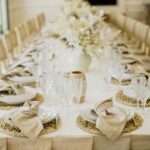 Neutral textured napkin beside simple ceramic dinnerware
