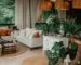 A bohemian living room with rattan pendant lights, jute rugs, white sofas, and layered greenery