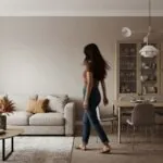 A warm greige living room with an empty painted wall, in Benjamin Moore quiet-luxury neutral tones