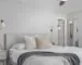 Neutral bedroom with a neatly made bed and layered white and gray blankets