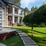 Landscaped home exterior with a clear perimeter around the foundation