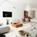 Bright staged living room with well-spaced seating and a clear circulation path