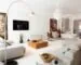 Bright staged living room with well-spaced seating and a clear circulation path