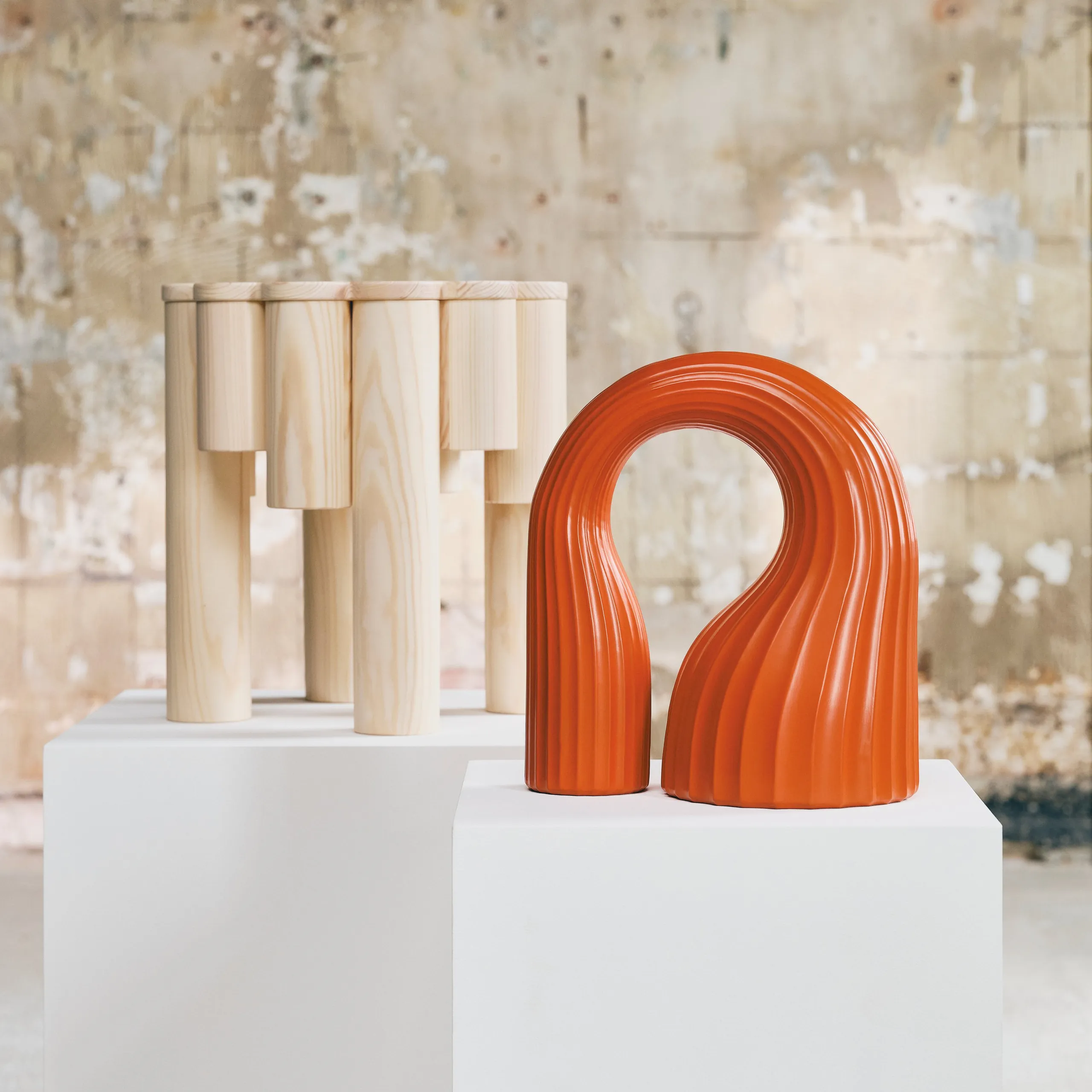 KONSTRUNDA pine stool and orange arched ceramic sculpture on white plinths