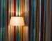 Striped curtains and a lit floor lamp illustrating color, light, and movement in an interior