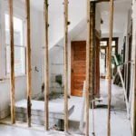 An interior under renovation with exposed timber wall framing