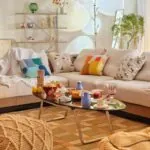 Warm small living room with a modular sofa, colorful cushions and a coffee table