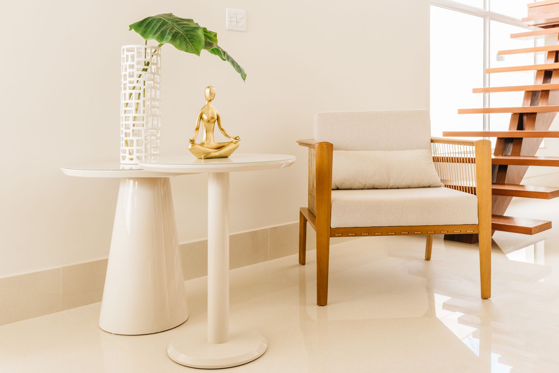 Sculptural armchair and round tables in a bright modern interior