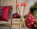A STRALA floor lamp shaped like three oversized wooden matchsticks with glowing red tips