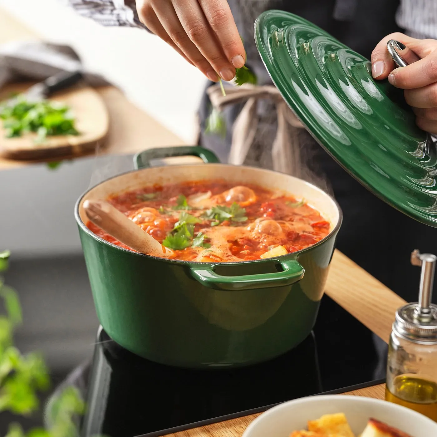 IKEA VARDAGEN 3.2-quart dark gray-green cast-iron pot of tomato stew on a stovetop, lid lifted