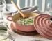 IKEA VARDAGEN 2.6-quart enamelled cast-iron pot in light pink with risotto, set on a dining table