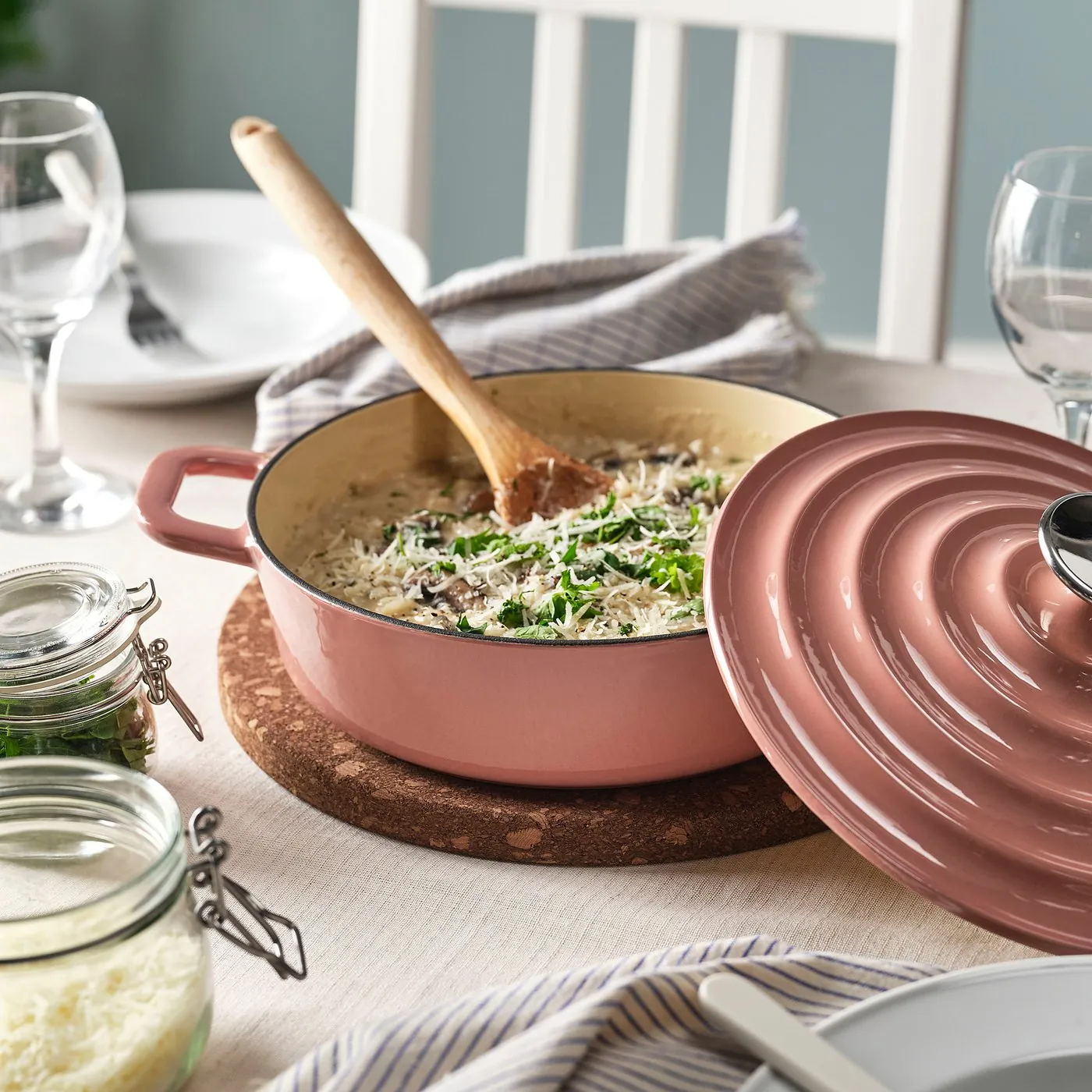 IKEA VARDAGEN 2.6-quart enamelled cast-iron pot in light pink with risotto, set on a dining table