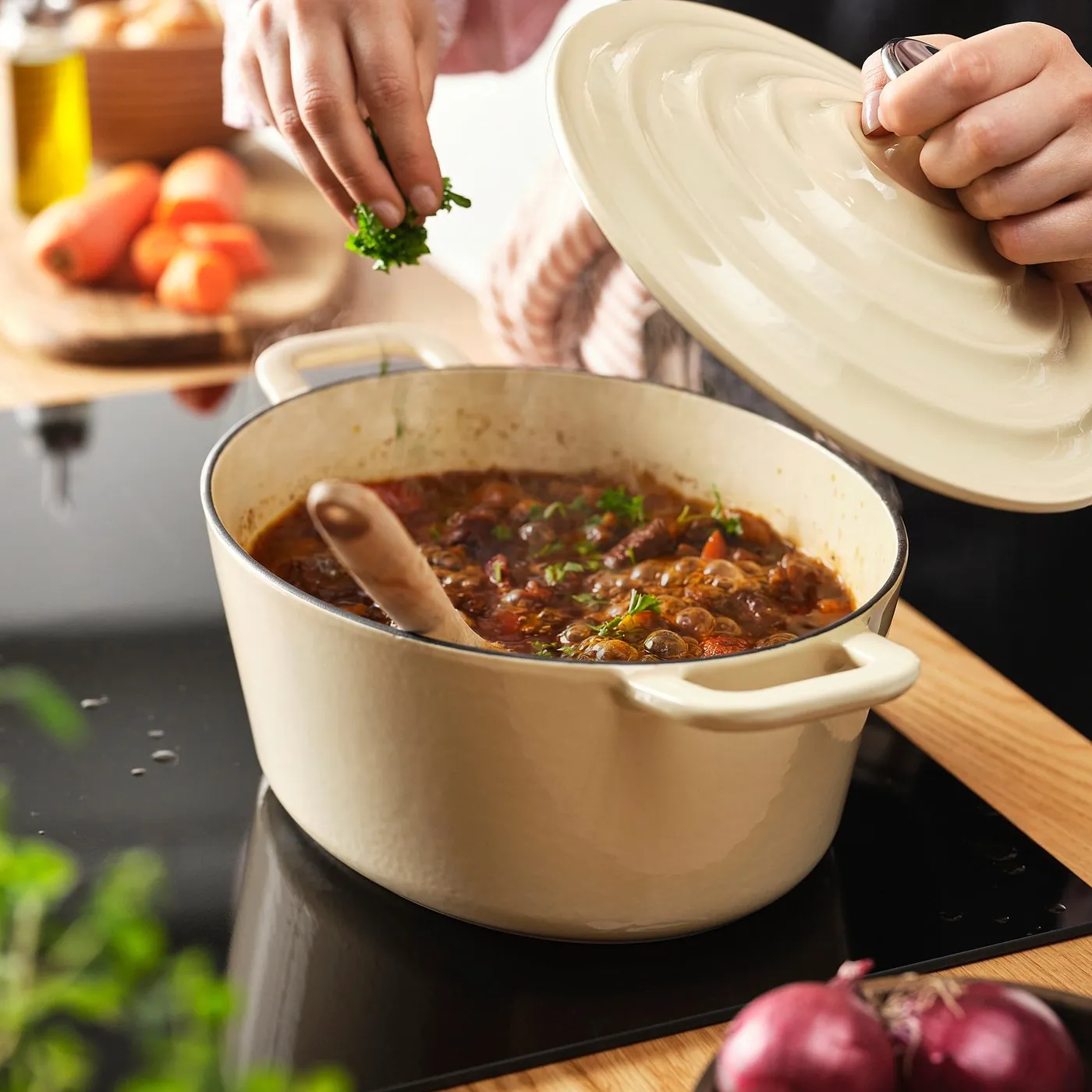 IKEA VARDAGEN 4.2-quart light yellow cast-iron pot of stew on a stovetop, lid lifted