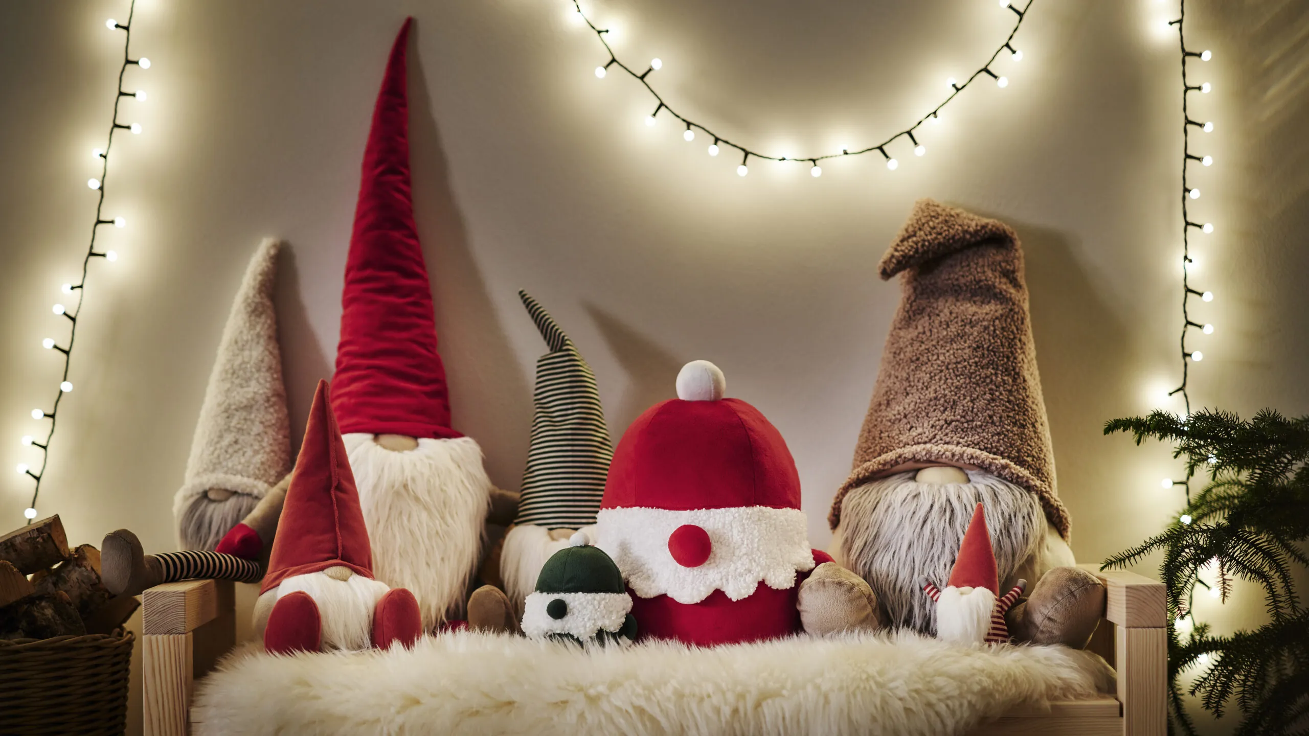 VINTERFINT plush holiday figures displayed together beneath warm string lights