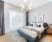 Modern bedroom with a large upholstered bed and clear walking space around it