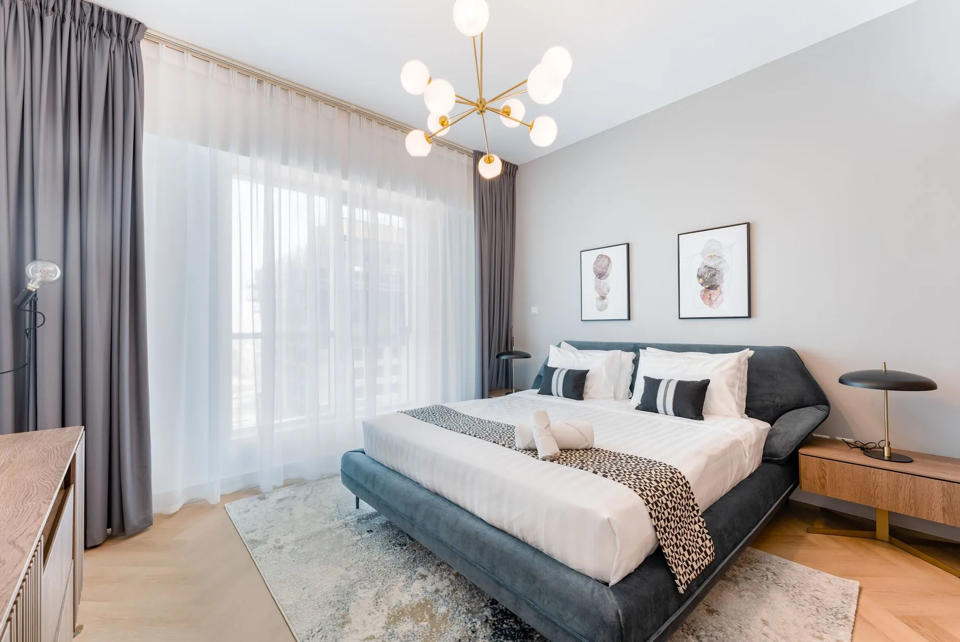 Modern bedroom with a large upholstered bed and clear walking space around it