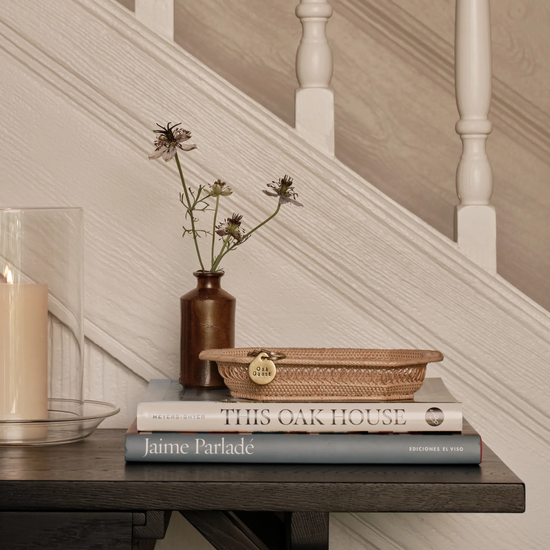 This Oak House collection tabletop styling with books, glassware and warm-toned decor