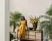 Venus Williams in a yellow dress beside a cabinet from her Crate and Barrel collection