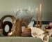 West Elm x Lone Fox holiday tablescape with faux bois vessels, an antler vase, taper candles, embroidered linens and tapestry pillows