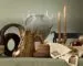 West Elm x Lone Fox holiday tablescape with faux bois vessels, an antler vase, taper candles, embroidered linens and tapestry pillows