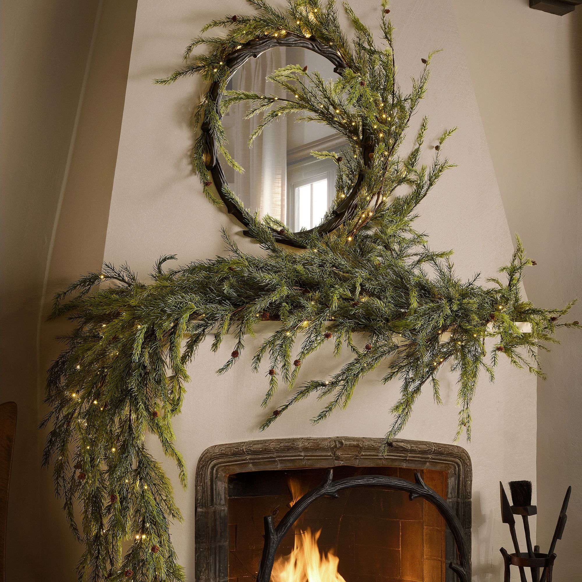 Lone Fox Oversized Garland draped along a fireplace mantel beneath a round mirror