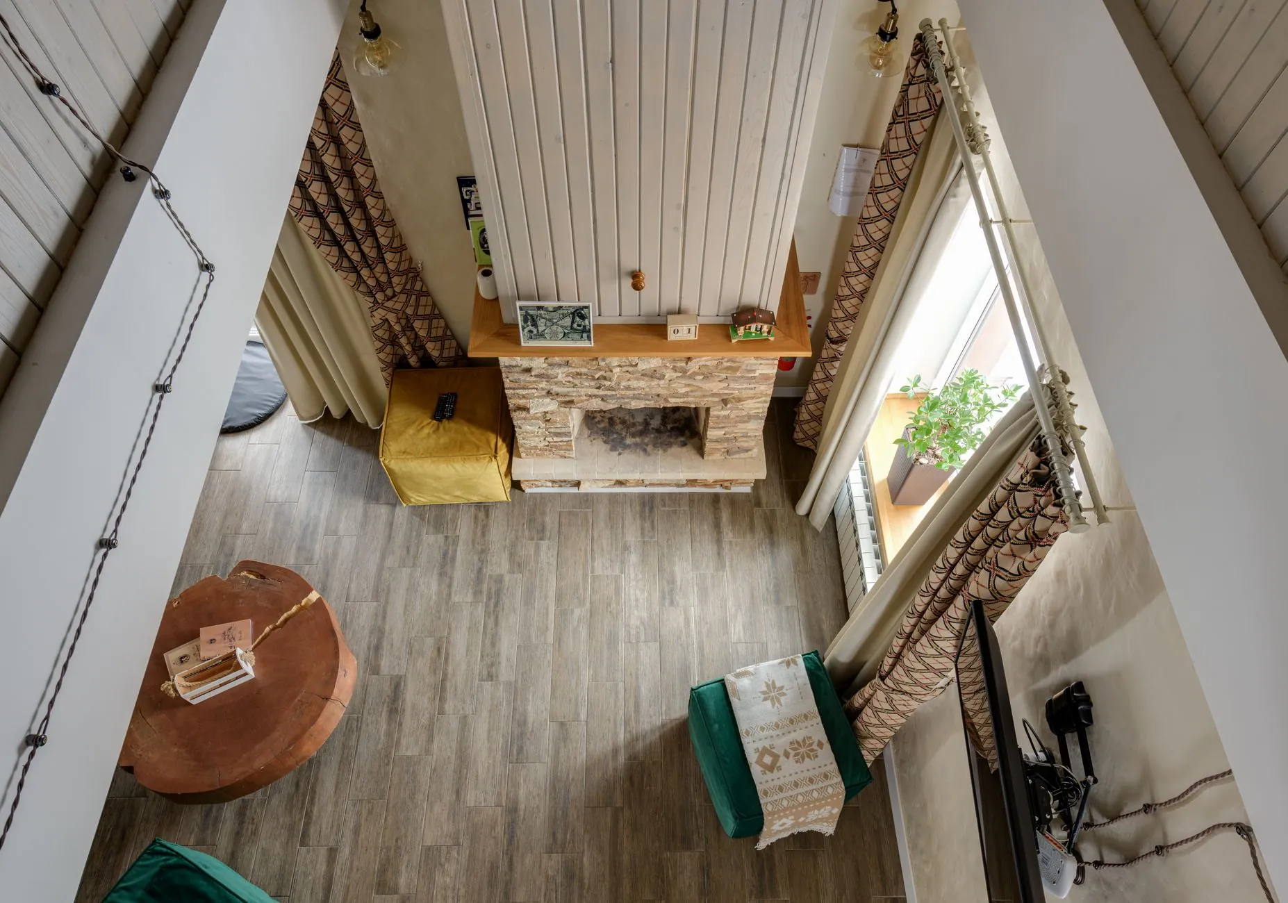 High-angle view of living room furniture arranged around a fireplace