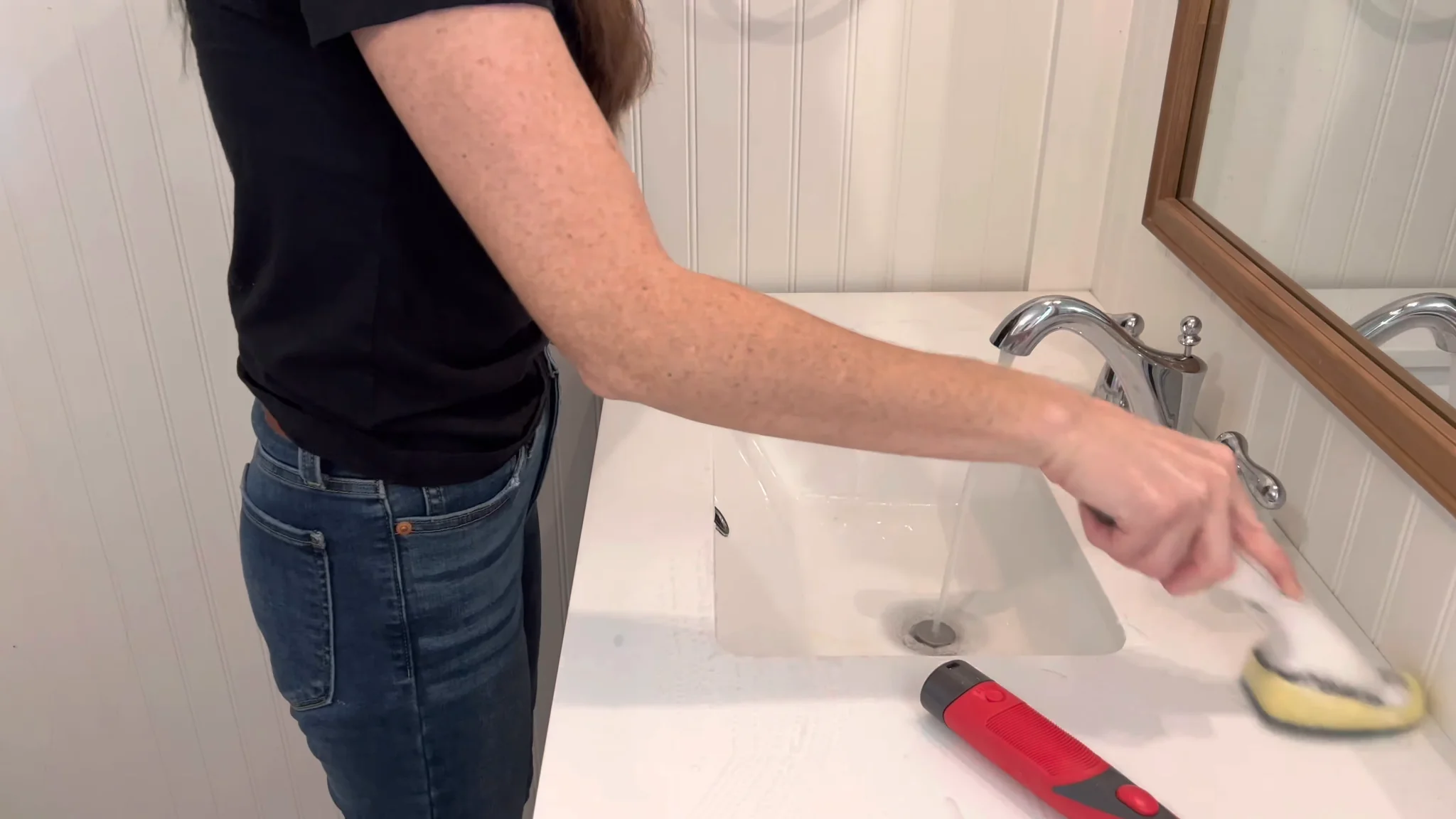 Professional cleaner scrubbing a bathroom sink