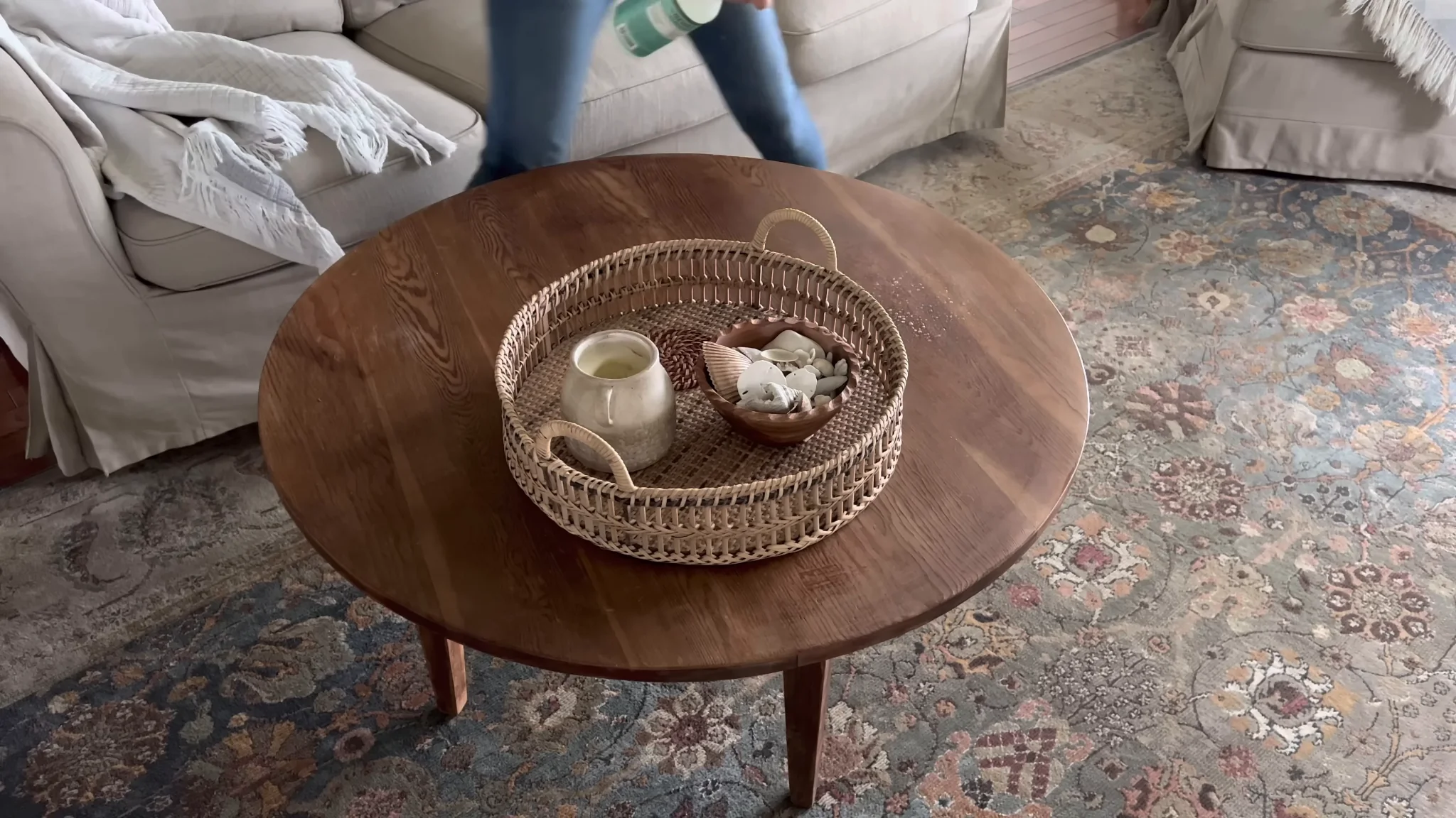 Cleaner dusting a coffee table in a New York apartment