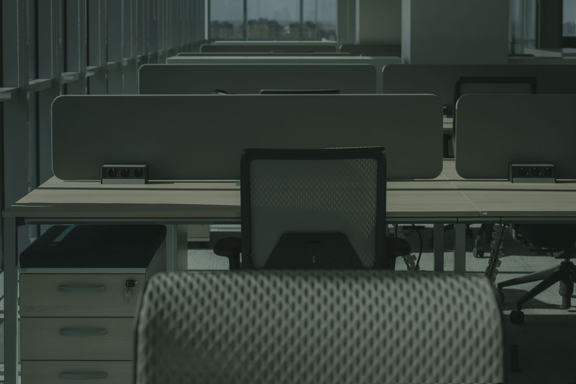 Mesh-backed office chairs in a modern shared workspace