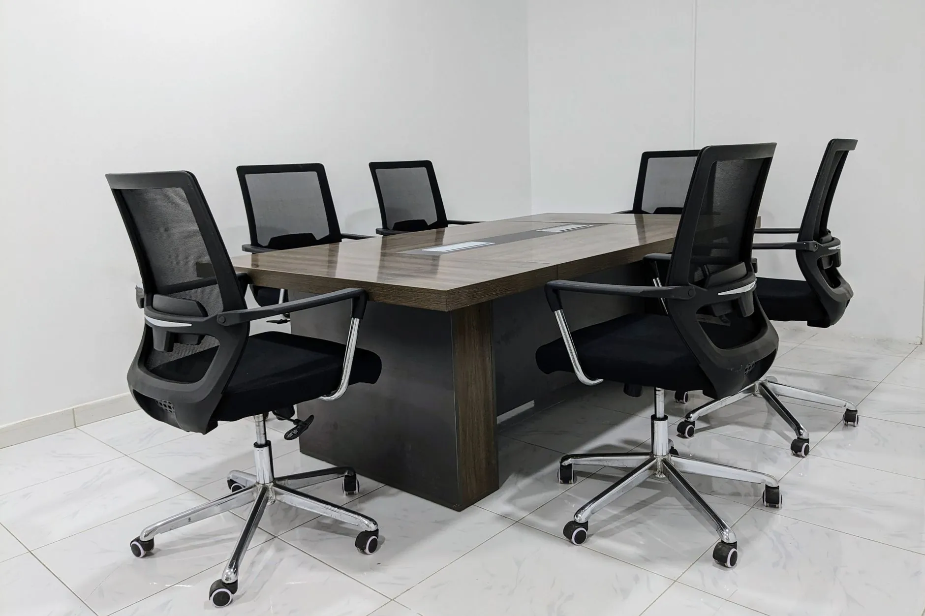 Office chairs with five-star bases and castors around a conference table