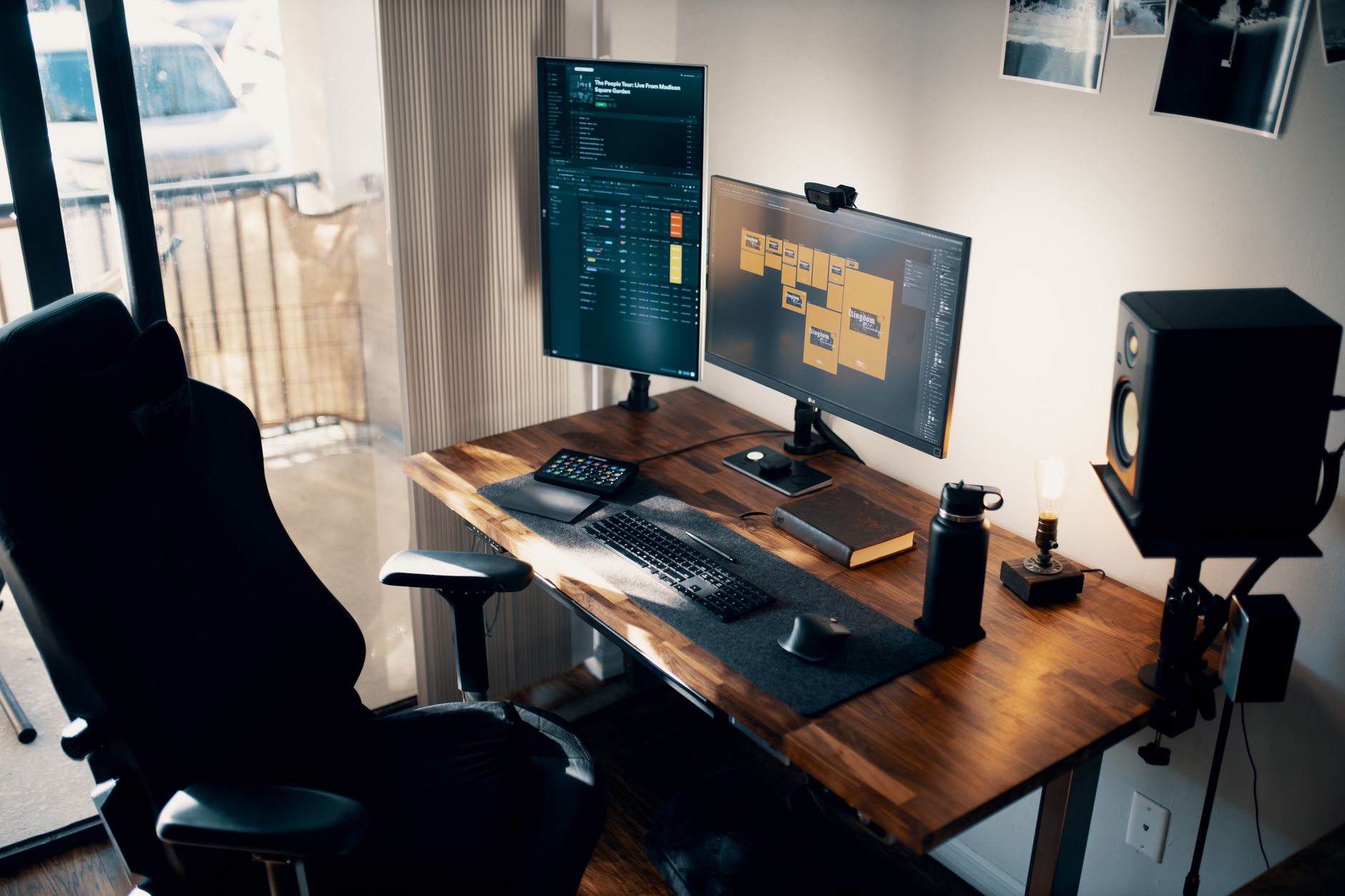 Ergonomic office chair beside a wooden desk with two monitors