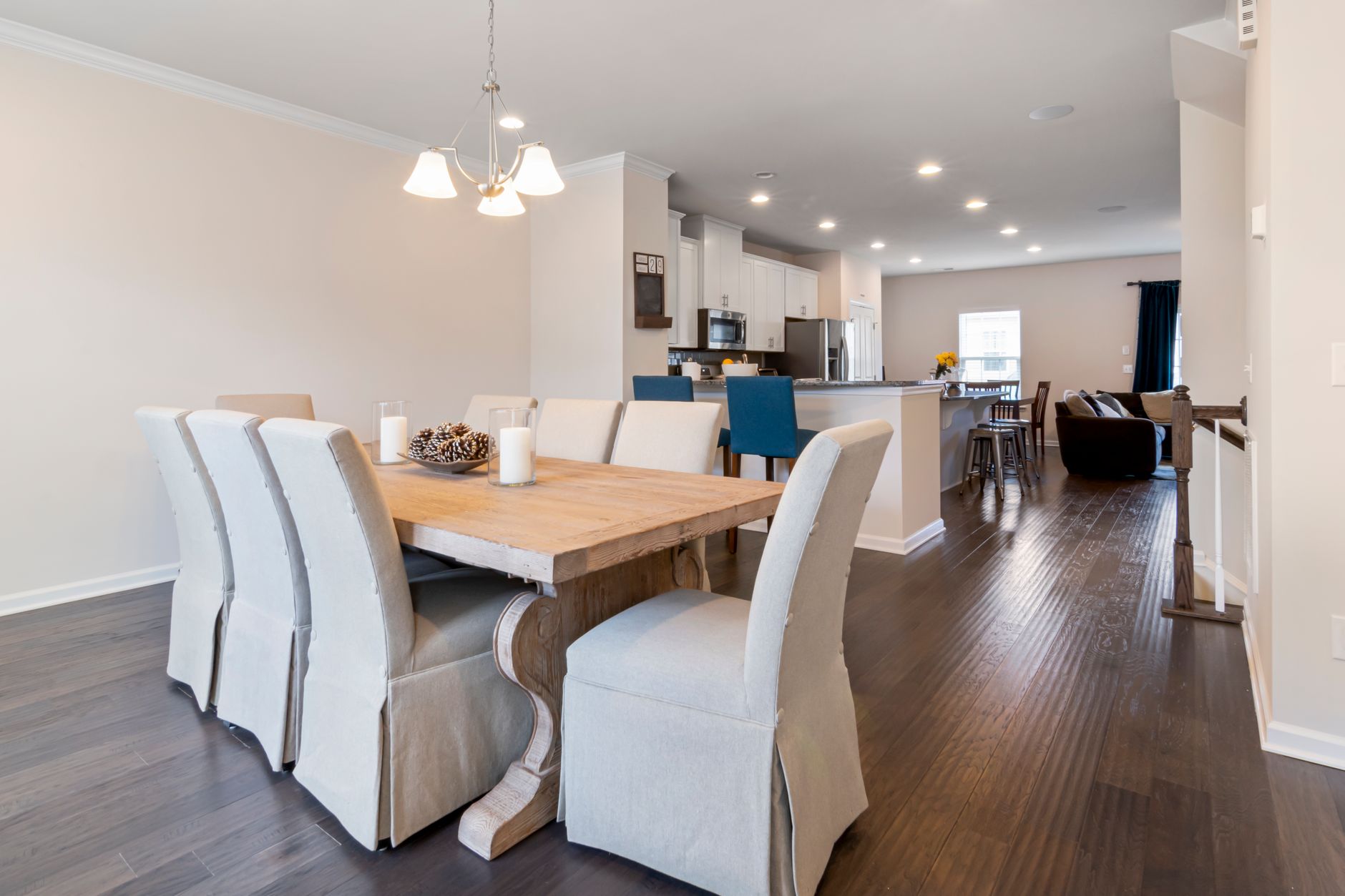 Upholstered dining chairs around a wooden table in an open family home